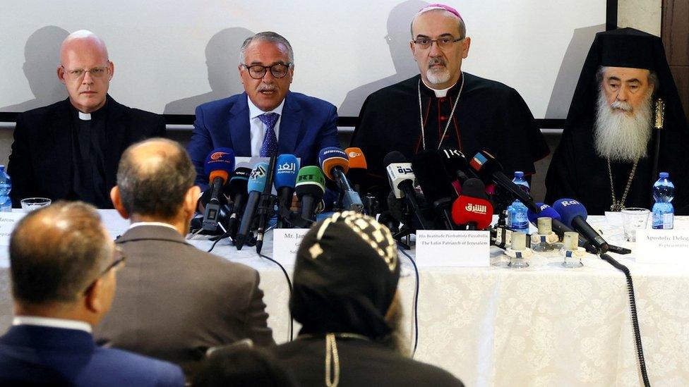 Monsignor Tomasz Grysa (L), St Joseph Hospital director Jamil Moussa (2nd L), Latin Patriarch Archbishop Pierbattista Pizzaballa (2nd R), and Greek Orthodox Patriarch Theophilos III (R) speak at a press conference in Jerusalem on 16 May 2022