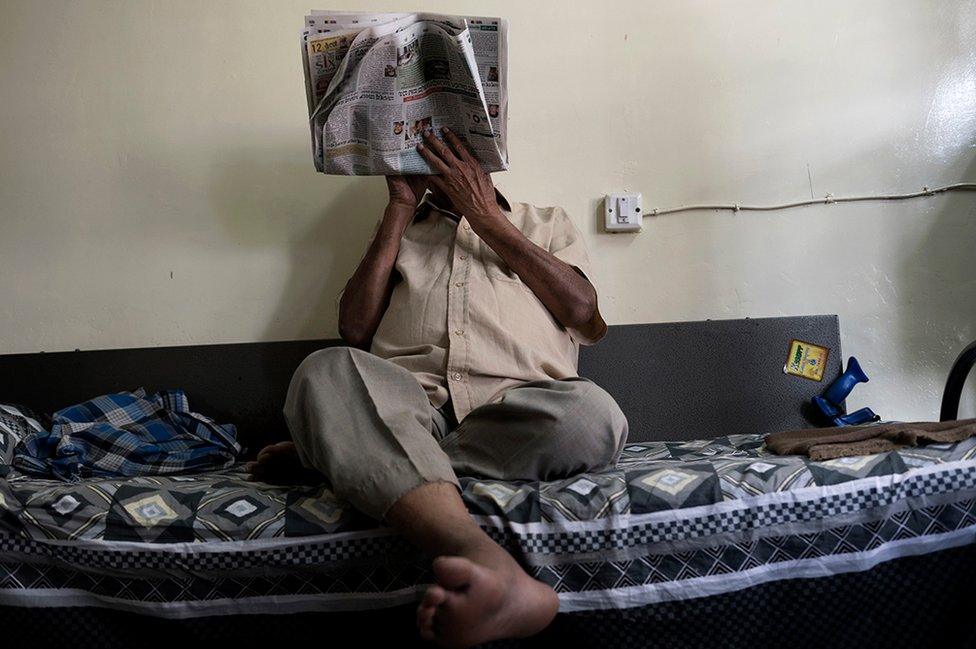 Mr Paramswar reading a newspaper