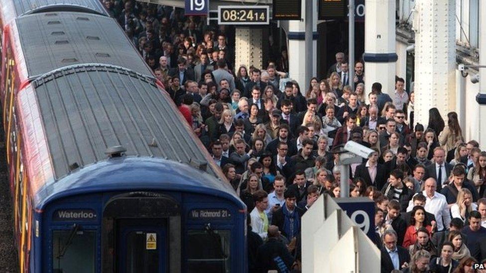 File photo dated 30/04/14 of commuters using overground train services waiting to pass through the barriers at Waterloo station, London, during strike by tube workers