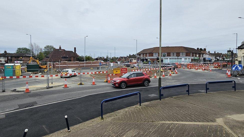 A red car passing the Heartsease roundabout