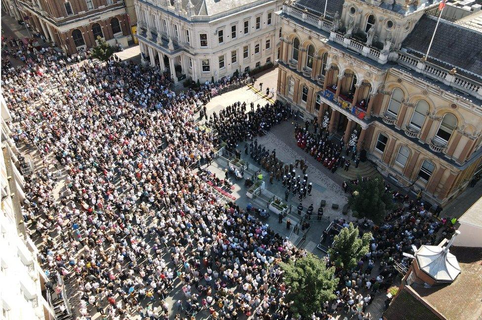 People listening to the proclamation on Ipswich's Cornhill