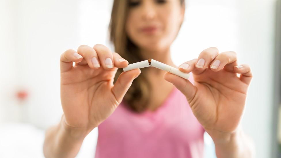 Woman snapping cigarette