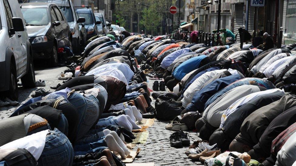 Muslims pray in the street as part of Friday's prayers on 8 April 2011 in Paris