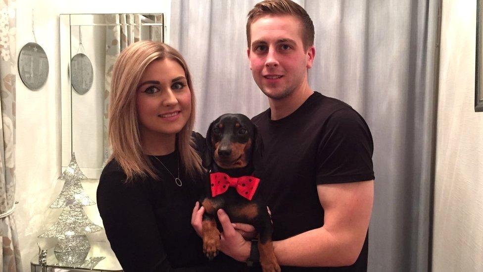 Couple cradling Harley in a bow tie