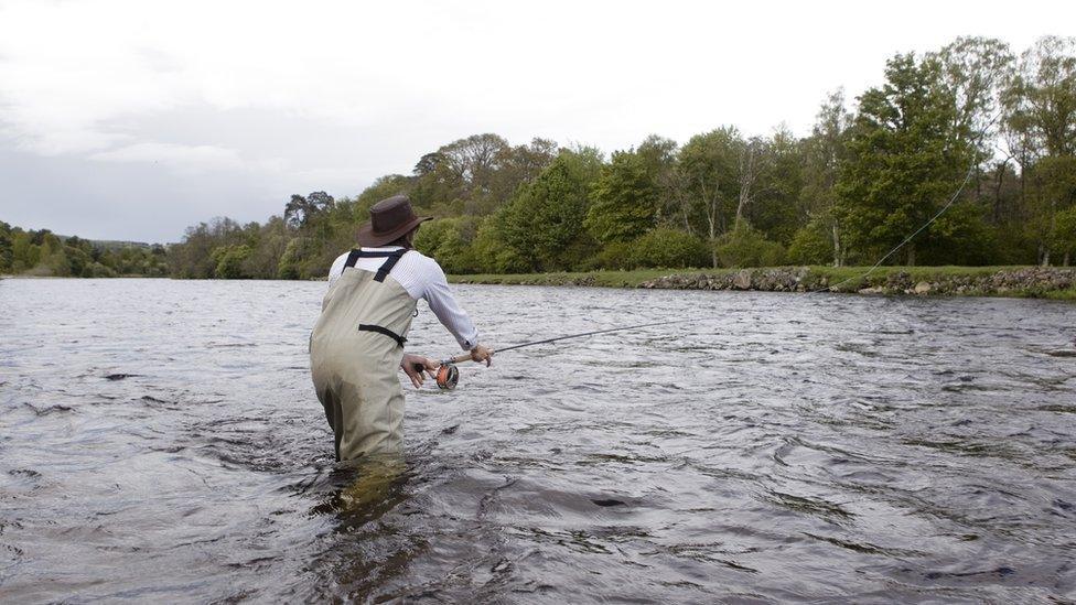 man fishing in river