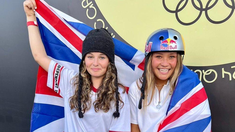 Lola Tambling and Sky Brown smiling holding a Union Jack flag