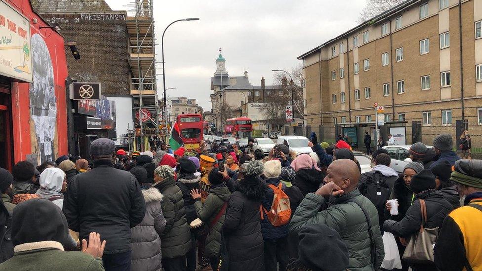 Crowd gather at the mural