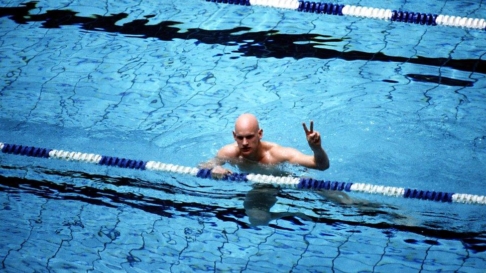 Duncan Goodhew giving a v sign after winning an Olympic gold medal