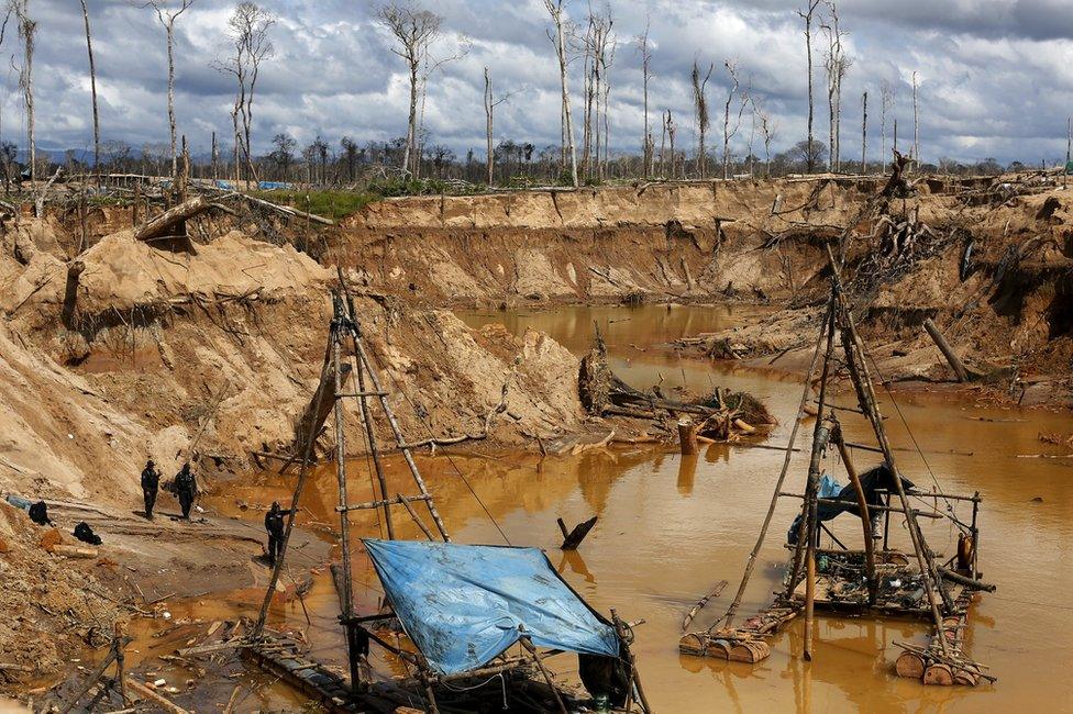 Peruvian police officers take part in an operation to destroy illegal gold mining camps in a zone known as Mega 14, in the southern Amazon region of Madre de Dios, Peru, 13 July 2015