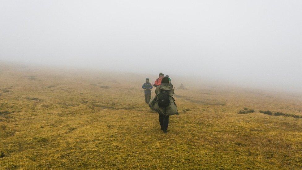 Green Group members work in heavy fog