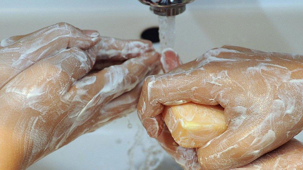 File image of people washing their hands with soap