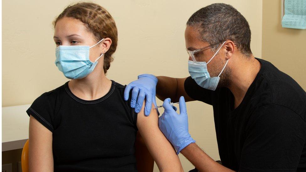 Girl being vaccinated