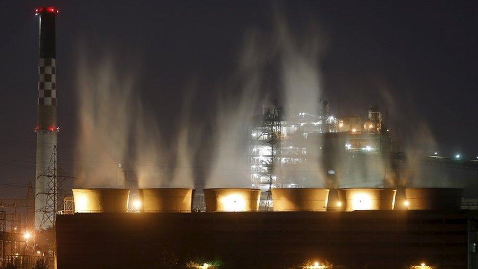 Smoke billows out from the cooling towers of a coal-fired power plant in Ahmedabad, India, November 20, 2015