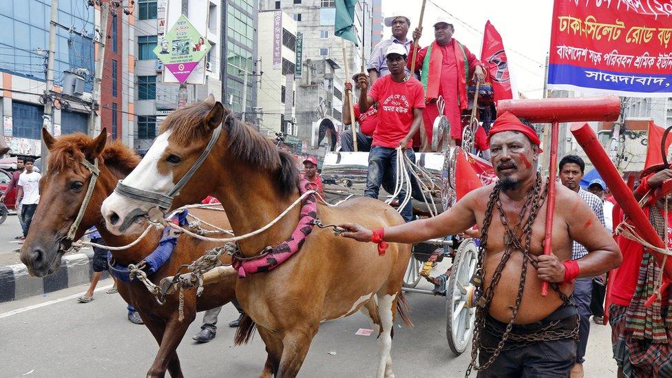 A Bangladeshi worker and activist wears a chain during a rally demanding an increase in minimum wages and safety in the work place during a May Day rally in Dhaka, Bangladesh, 01 May 2018.