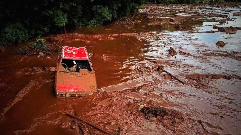 A car in a sea of muddy sludge in Brumadinho