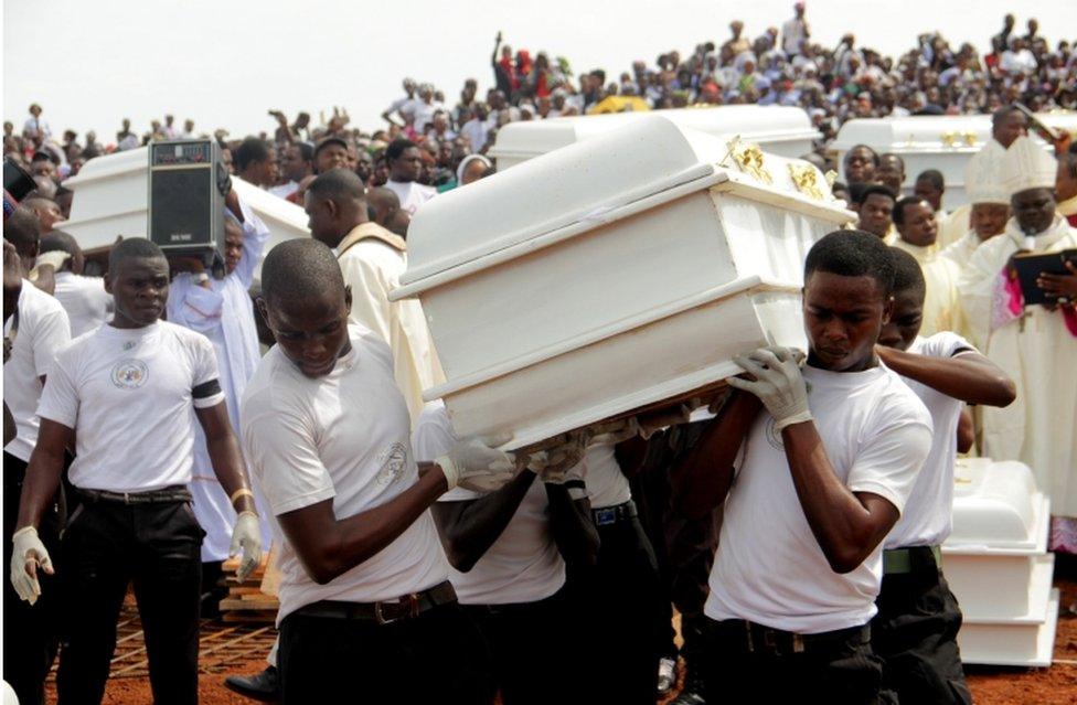 Coffins are carried during a funeral service for 17 worshippers and two priests, who were allegedly killed by Fulani herdsmen in Benue State, north-central Nigeria on May 22, 2018.