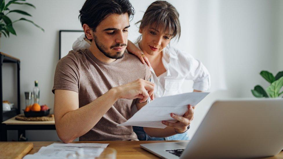 A couple looking at financial paperwork