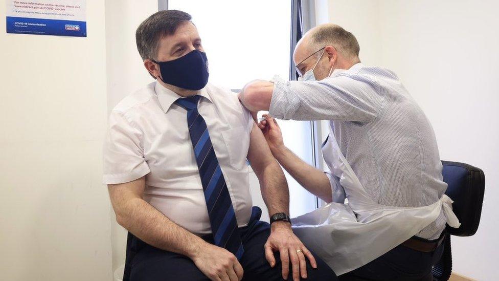 Robin Swann receiving vaccine