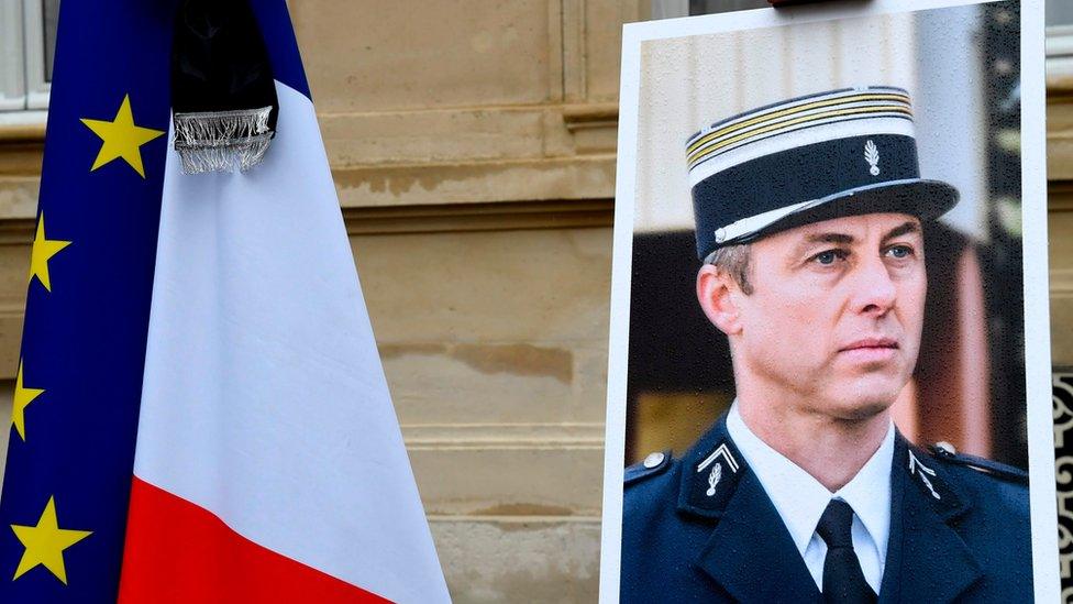 A portrait of French Lieutenant-Colonel Arnaud Beltrame is pictured during a minute of silence