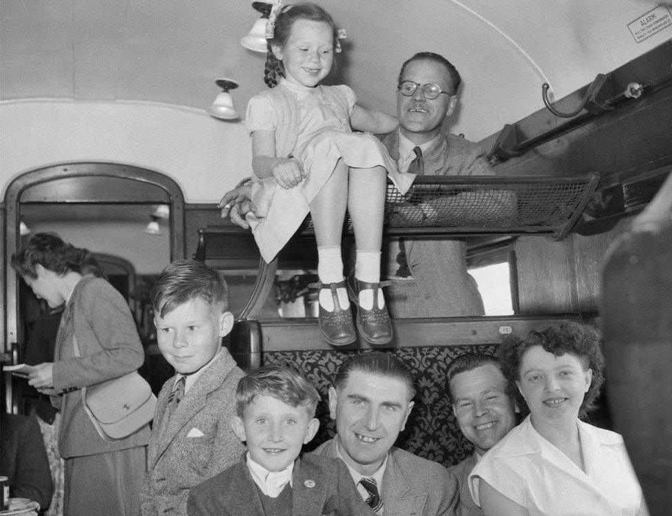 Children and adults crammed together in carriage