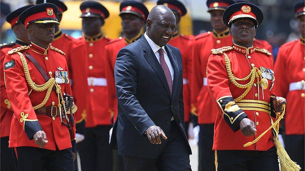 Kenya's President William Ruto (C) speaks with Chief of Defence Forces, General Robert Kibochi (R) after he inspected a guard of honour during the Mashujaa Day 'Heroes' Day' celebrations, which honours all who have contributed to the fight for Kenya's freedom, at the Uhuru grounds in Nairobi on October 20, 2022.