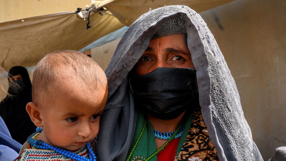 In this picture taken on March 28, 2021, Farzana, who fled her village in Helmand province when it was taken over by the Taliban, waits to see a doctor at a mobile clinic for women and children set up at the residence of a local elder in Yarmuhamad village, near Lashkar Gah in Helmand province.