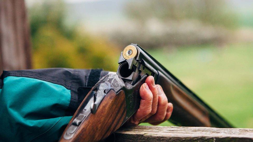 A shotgun being loaded