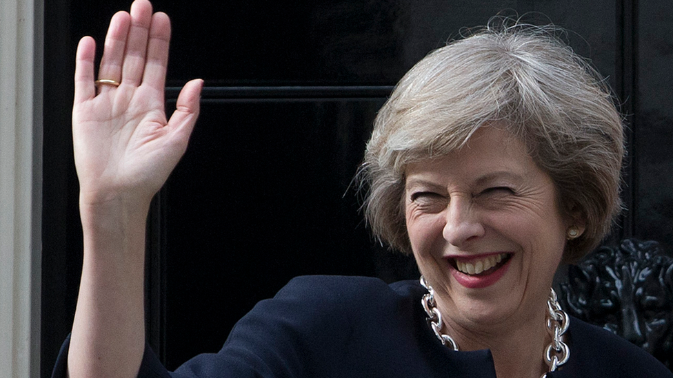 Theresa May waving