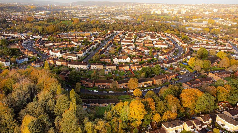 The rising sun lights up a housing estate full of autumn trees in east Bristol.