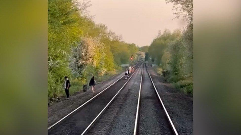 Children could be seen running along the railway tracks