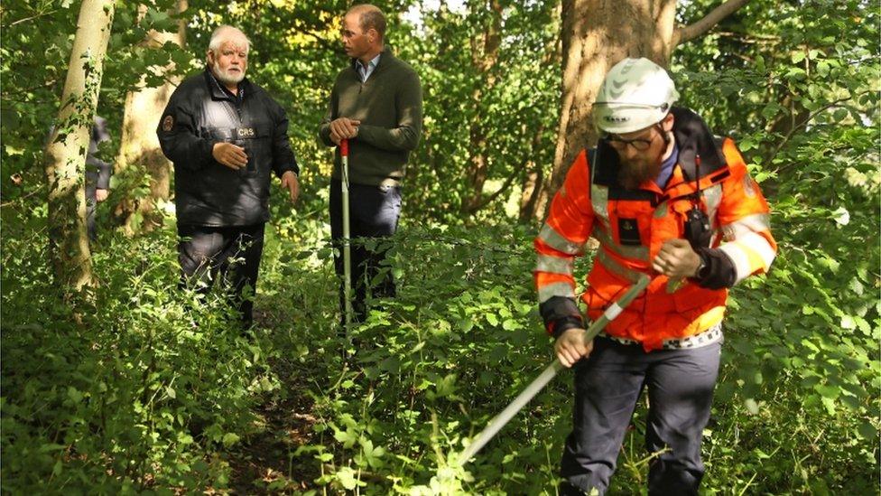 The Duke of Cambridge (centre) with Community Rescue Service (CRS) founder and regional commander Sean McCarry (left) watch a search demonstration during a visit to the CRS at Cave Hill Country Park