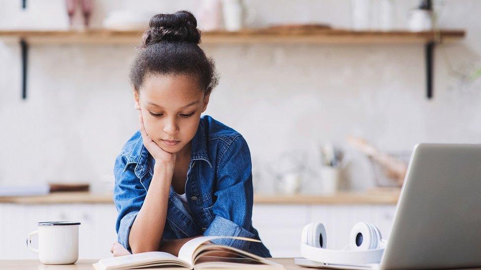 Girl studying in kitchen