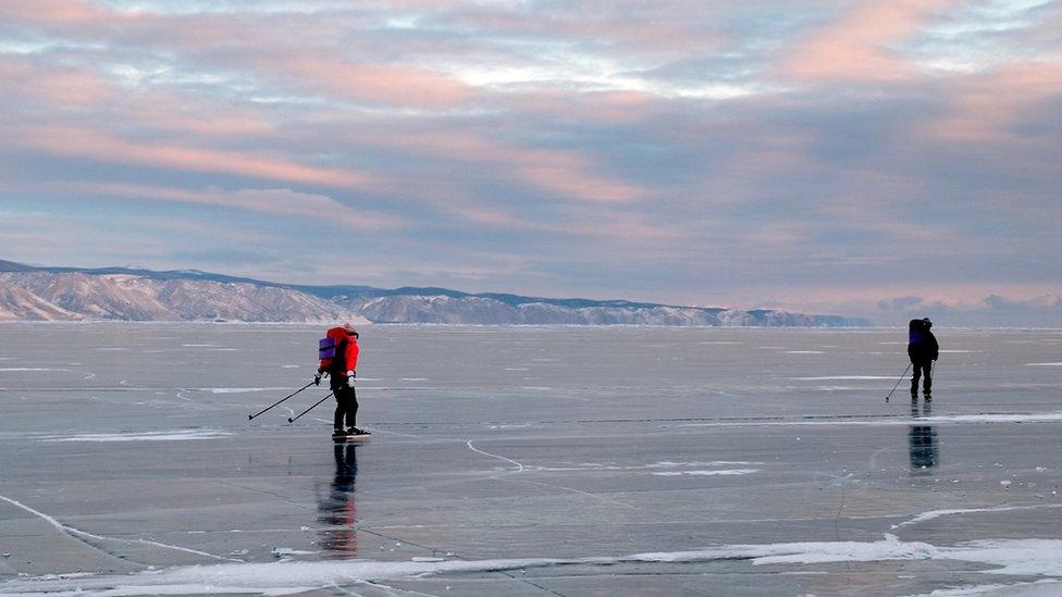 Two men skating on the frozen lake