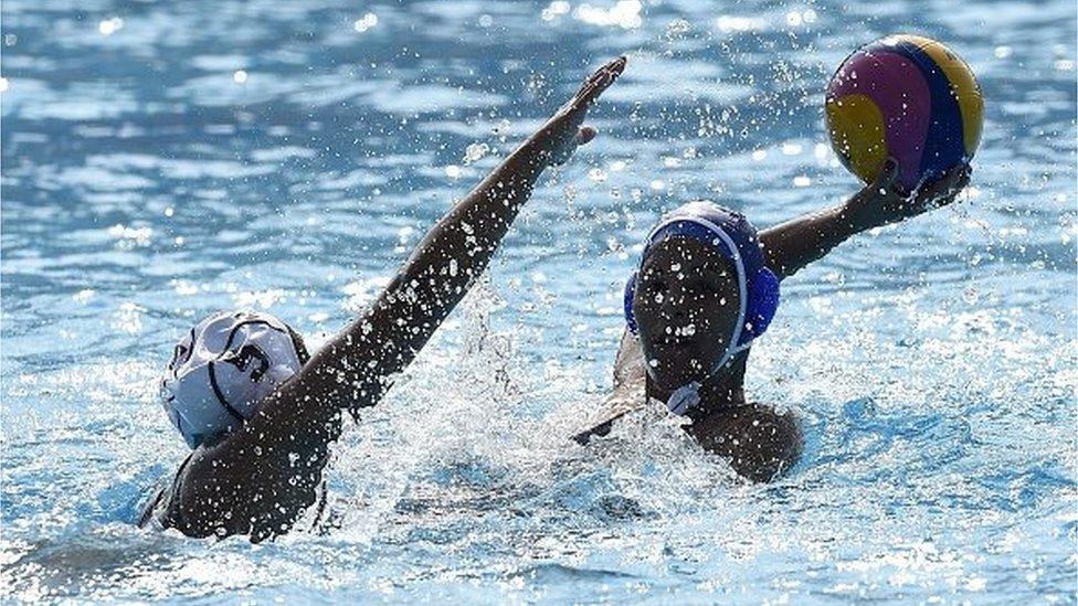 Ivana Castro (L) from Mexico vies for the ball with a player from Cuba, during the women qualification round of Water Polo competition, at the XXII Central American and Caribbean Games, in Veracruz, Mexico, on November 24, 2014.