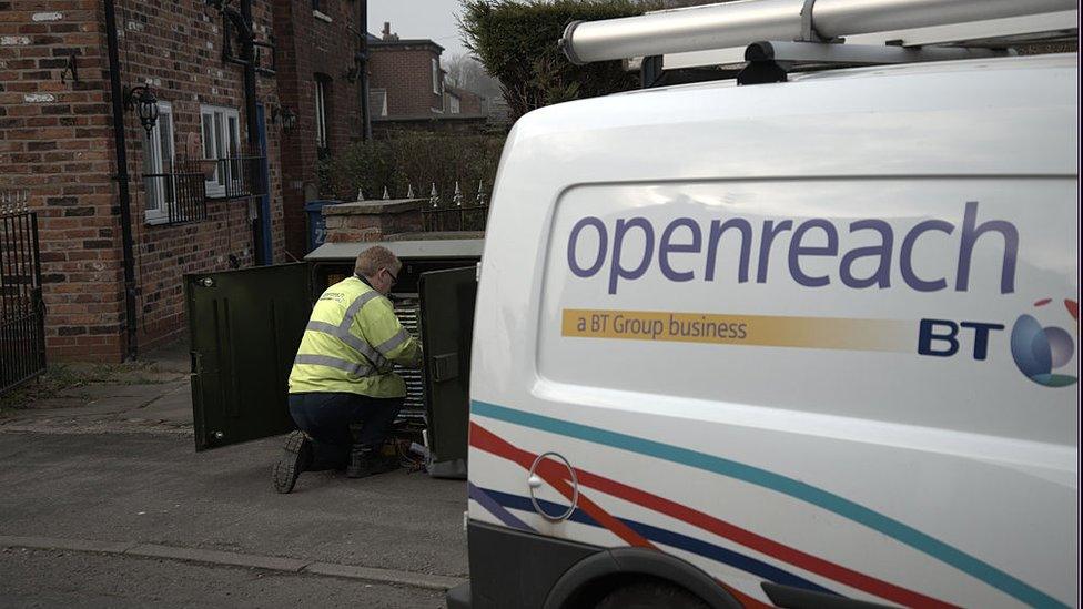 An Openreach worker next to a company van