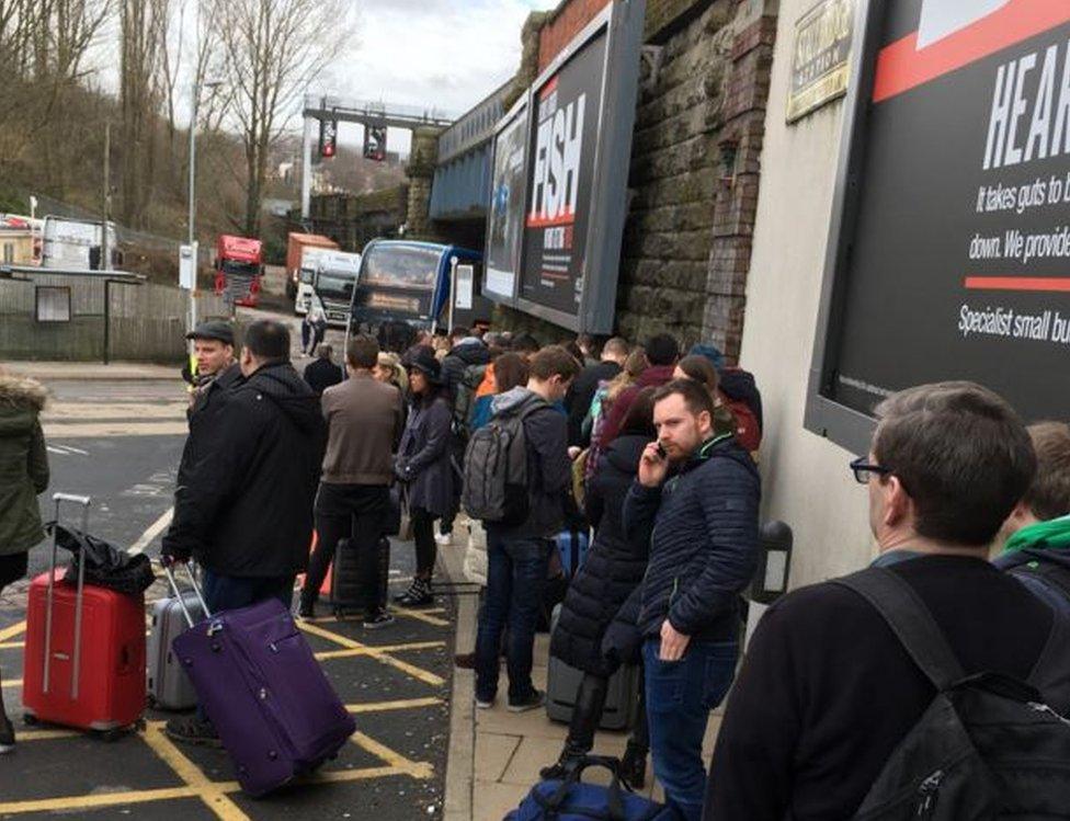 People waiting for bus replacements