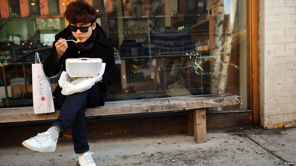 Man eats out of container, New York City