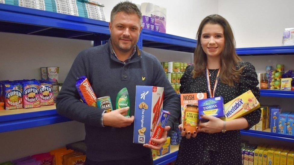 Rob Hickey and Aimee Yeoman holding food at the larder