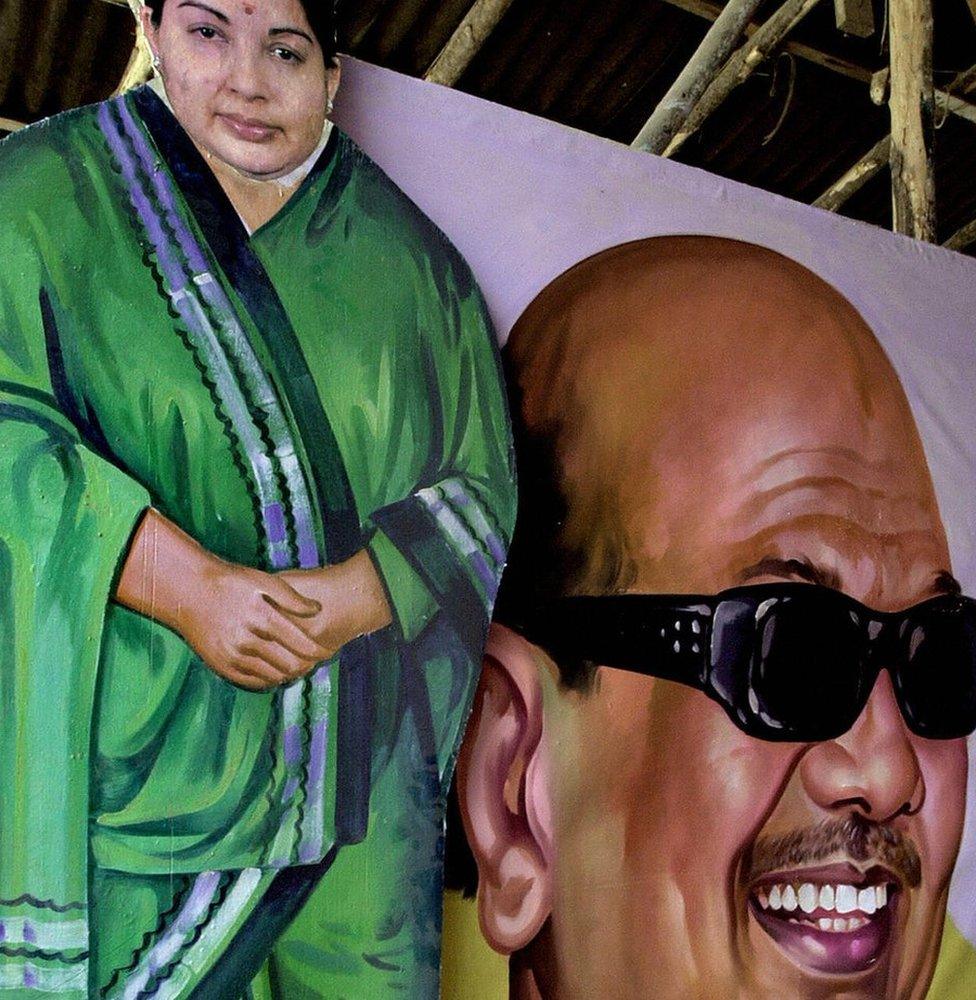 Indian painter, Venkatesh, 30, puts the final touch to a portrait of the president of the political party Dravida Munnetra Kazhagam (DMK), M.Karunanidhi, next to a cut-out of All India Dravida Munnetra Kazhagam (AIDMK) leader and Chief Minister J.Jayalalithaa