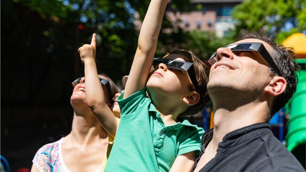 Family looking at the eclipse