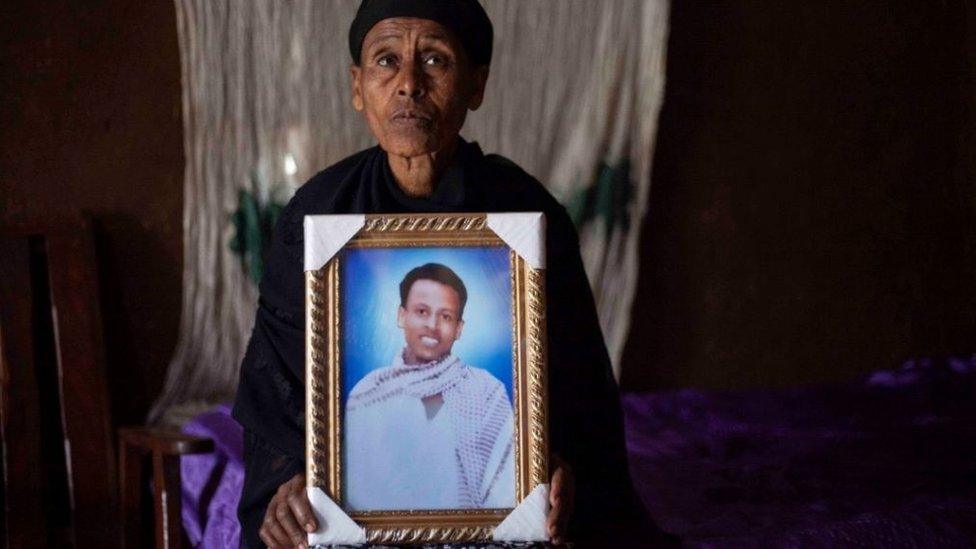 Likitu Merdasa holds a portrait of her son Desta Garuma, a 27-year-old rickshaw driver, allegedly killed by security forces, while at her home in Nekemte, West Oromia, on February 26, 2020