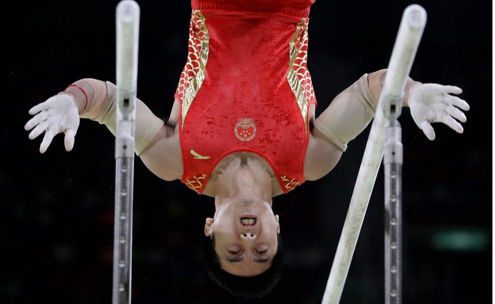 China's You Hao performs on the parallel bars during the artistic gymnastics men's apparatus final at the 2016 Summer Olympics in Rio de Janeiro, Brazil, 16 August 2016