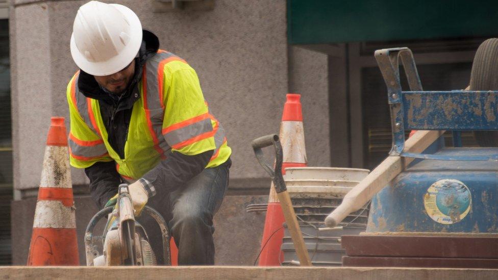 Men work on a construction site in Washington, DC, on December 8, 2017.