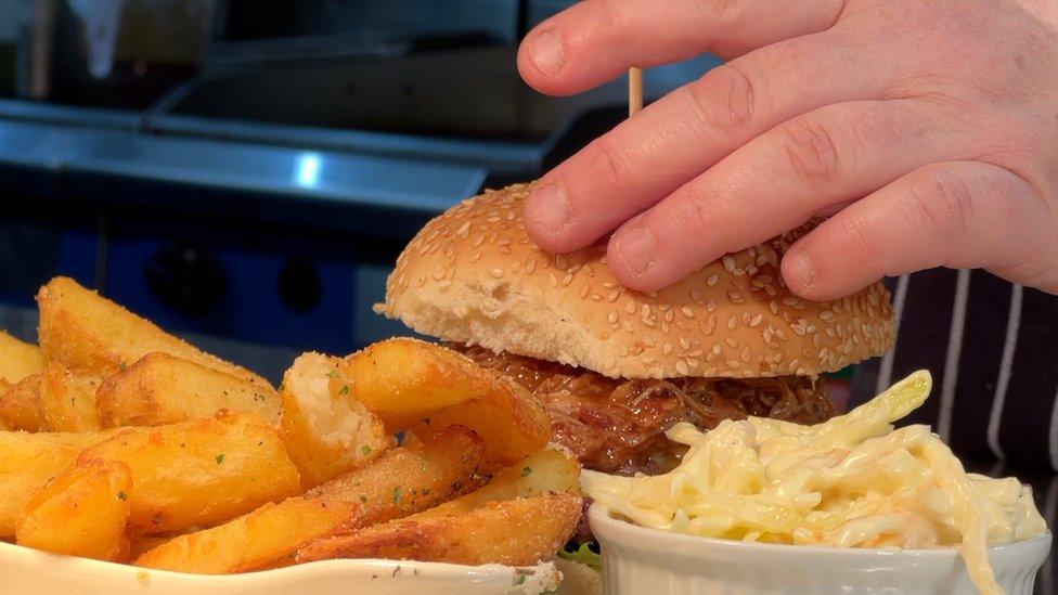 A burger being prepared at a country pub