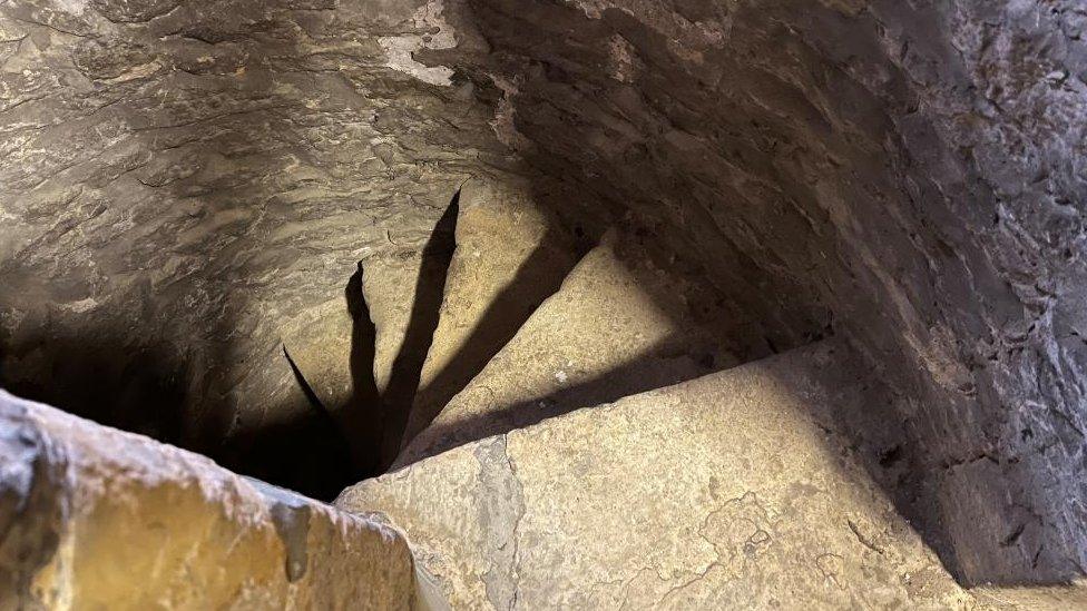 Stone steps inside a tower, showing how they have been worn by feet over the years