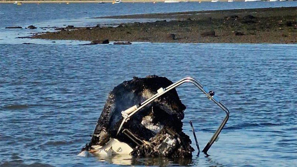 the burnt boat in the water