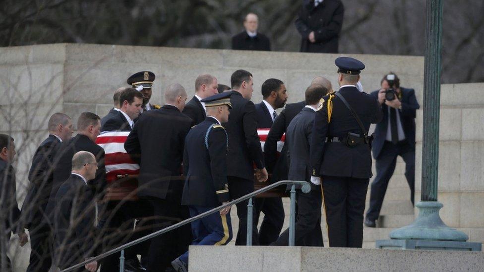 Pallbearers carry the coffin into the basilica for the Mass, 20 Feb