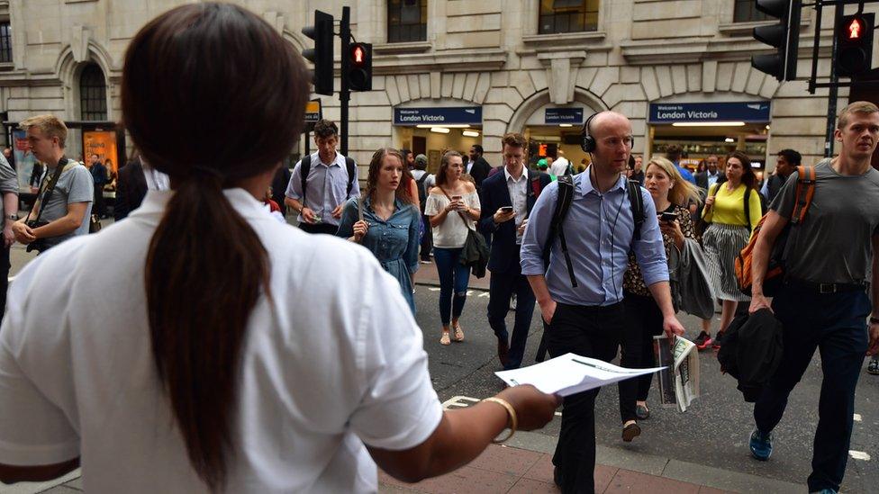 Rail worker hands out flyers
