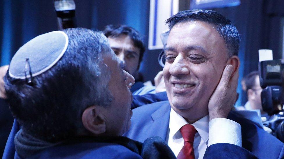 Avi Gabbay (R), chairman of Israel's Labour Party, meets with a supporter during a party conference in the coastal city of Tel Aviv on 10 January 2019.