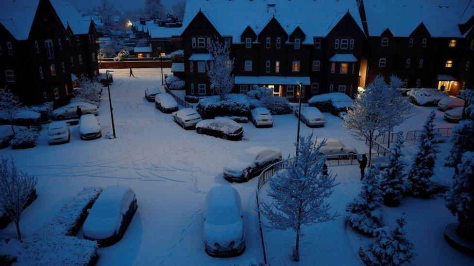 People walk along a snow covered road in Altrincham, Britain, January 30, 2019.